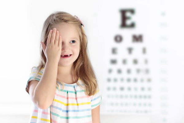 Child at eye sight test. Kid at optician. Eyewear for kids.
