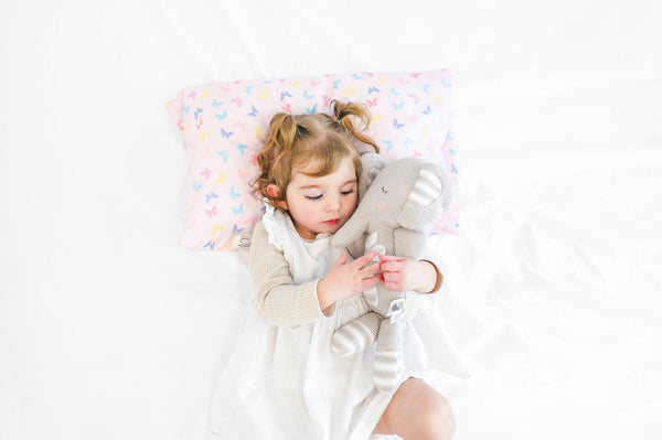 sleeping girl hugging her KeaBabies Toddler Pillow