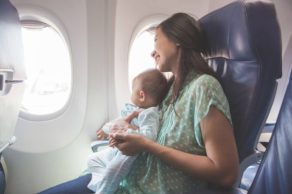 Mother and baby sitting in airplane