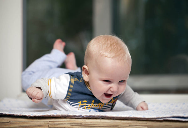 Five month old baby boy lying on stomach