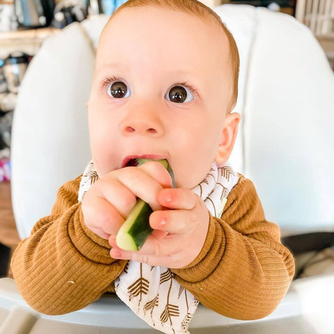 baby boy eating vegetable