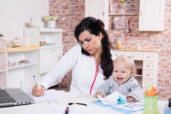 Mother with baby preparing travel documents