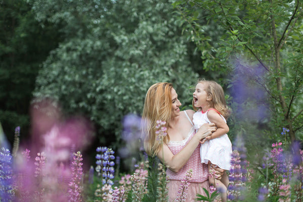 Mom holds her daughter in her arms