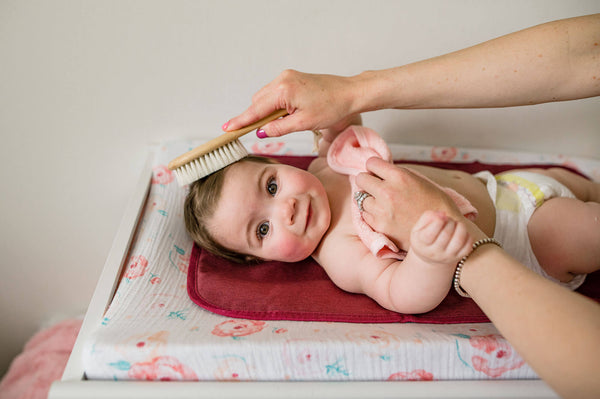 brushing baby's hair with KeaBabies hairbrush