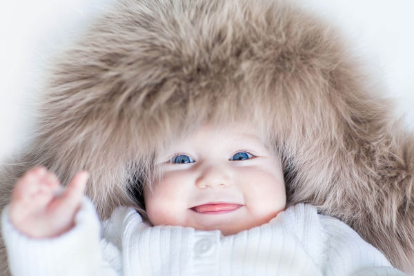cute baby in a cozy fur hood