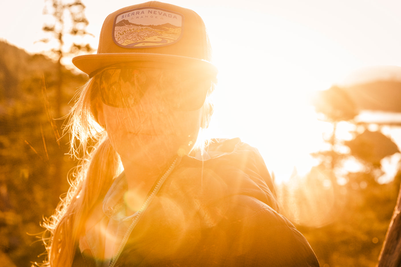 Sendero hat on a girl with sunset behind her