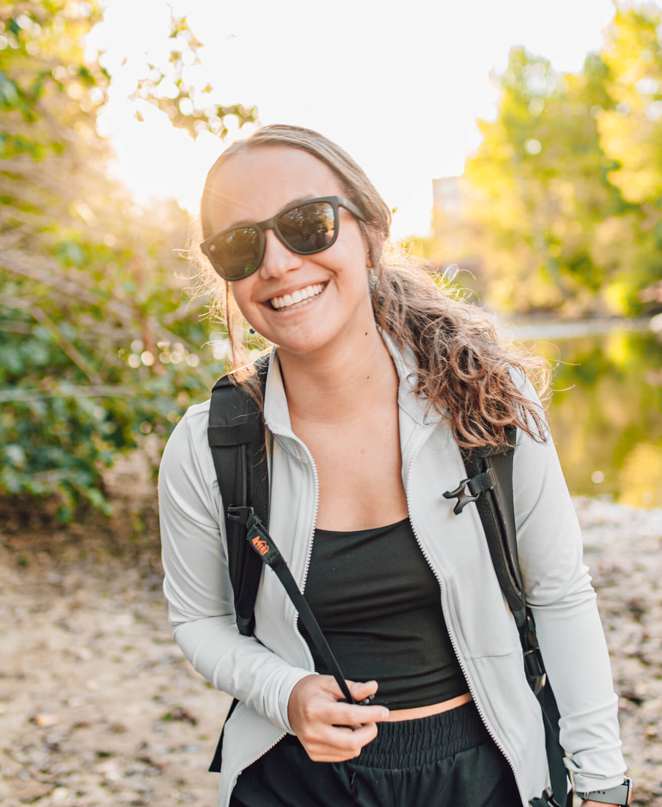 woman smiling by a river