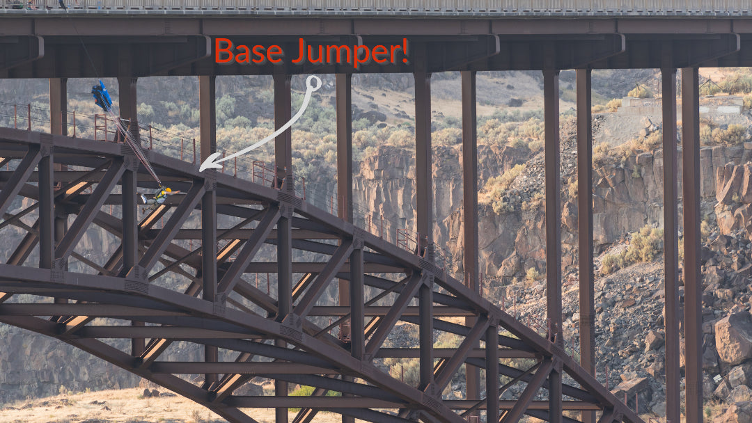 a base jumper opens his chute after jumping off of perrine bridge