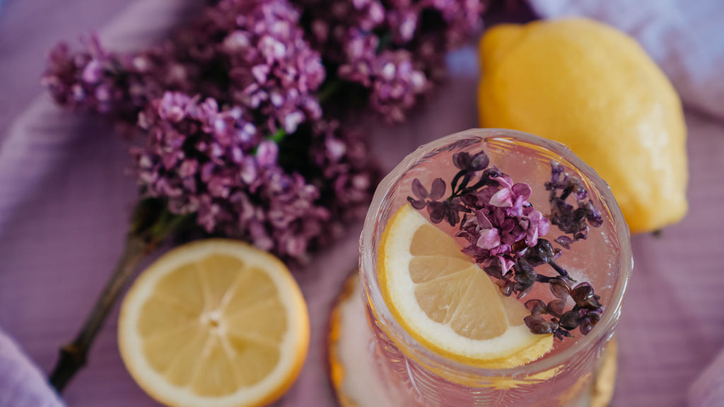 Lilac flowers, lemon and drink