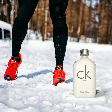 runners legs outside in the snow next to bottle of CK One