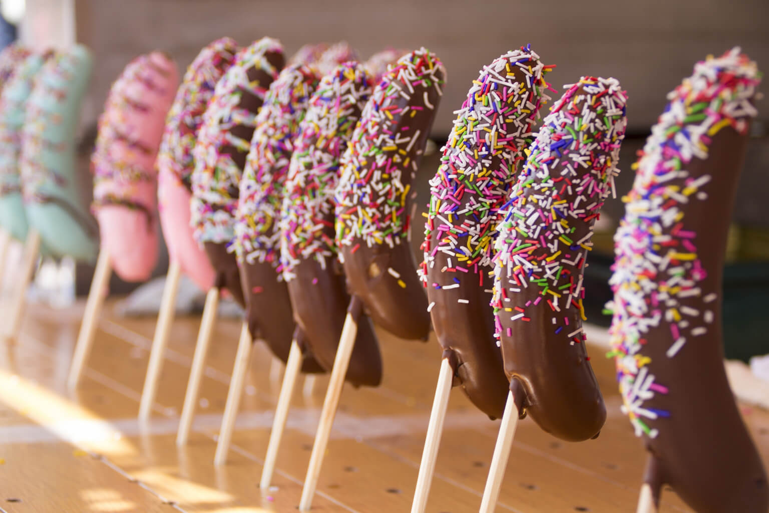 It is a chocolate-coated banana on a stick