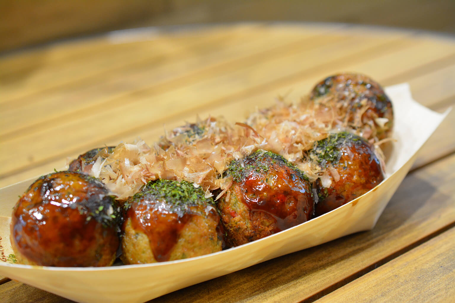 Takoyaki are pancake balls made with flour-based batter, diced octopus, and a few other ingredients such as scallions and ginger