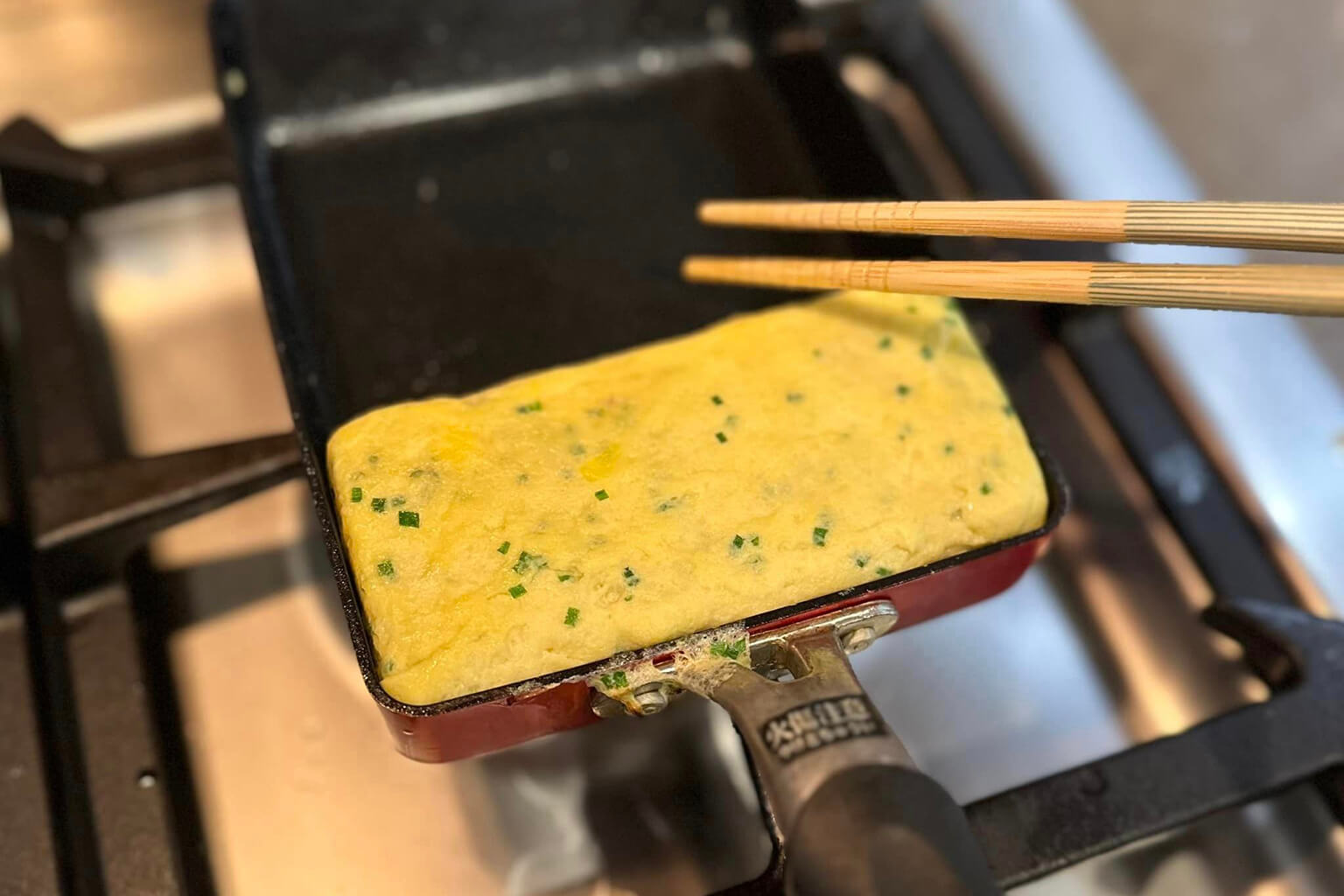 On a heated pan, add vegetable oil, then add ¼ of the egg mixture.