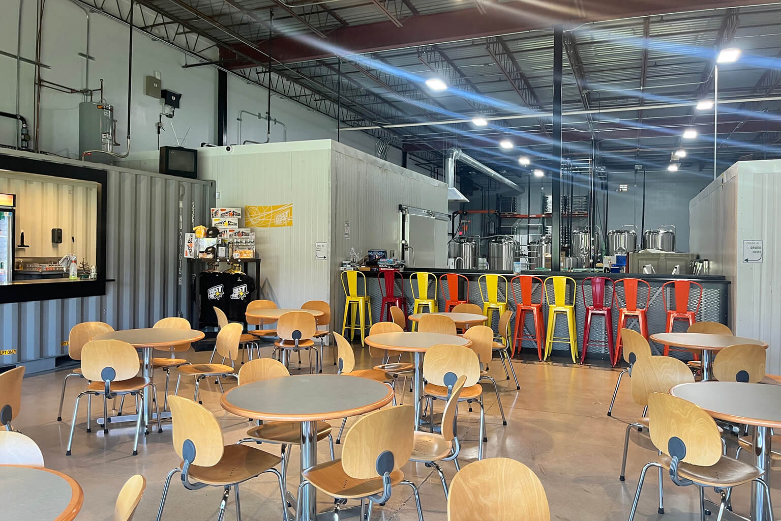 The taproom features an unobstructed view of the brewery in the back of the facility