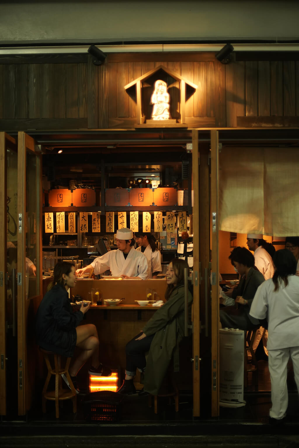 Customers are enjoying eating at Japanese izakaya