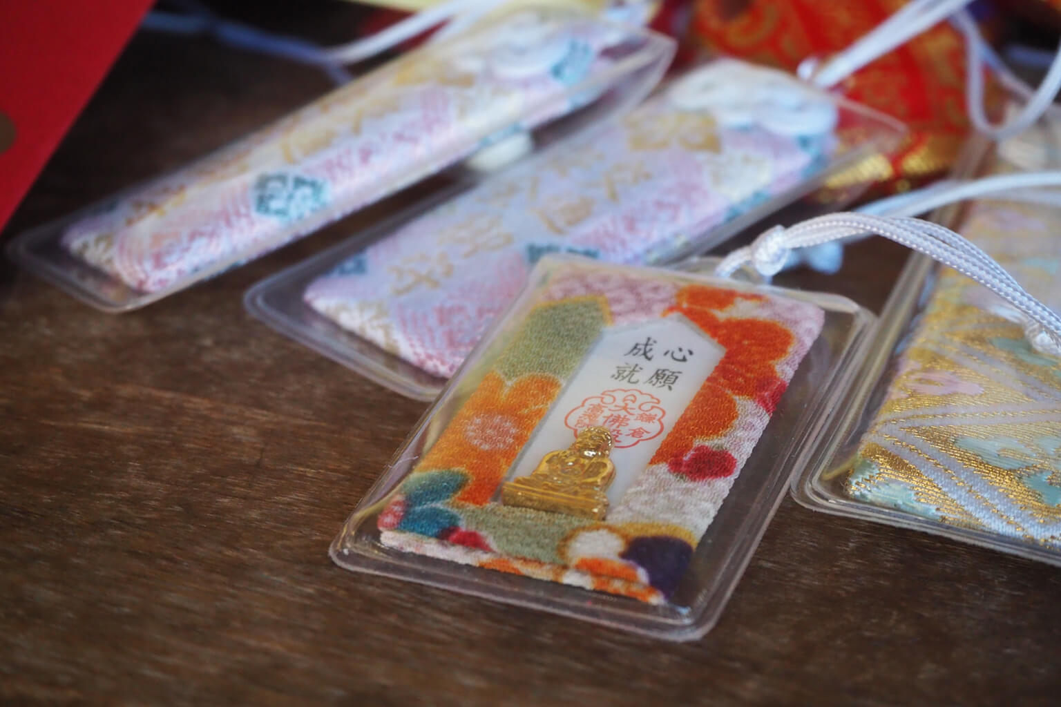 This omamori comes with a small, gold-colored Buddha