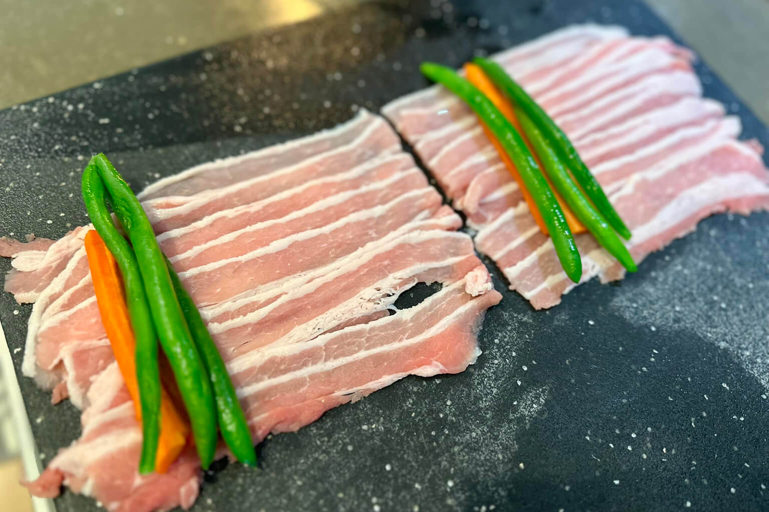 Lay pork belly slices flat, side by side.