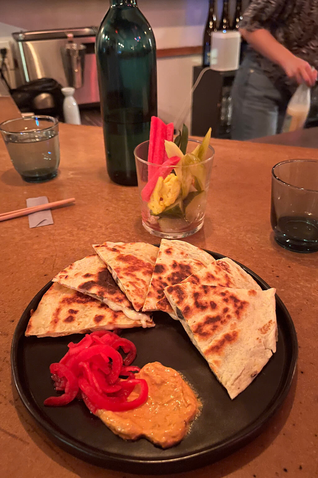 The huitlacoche quesadilla is made with mozzarella cheese and nori, served with pickled red onions and spicy mayo.