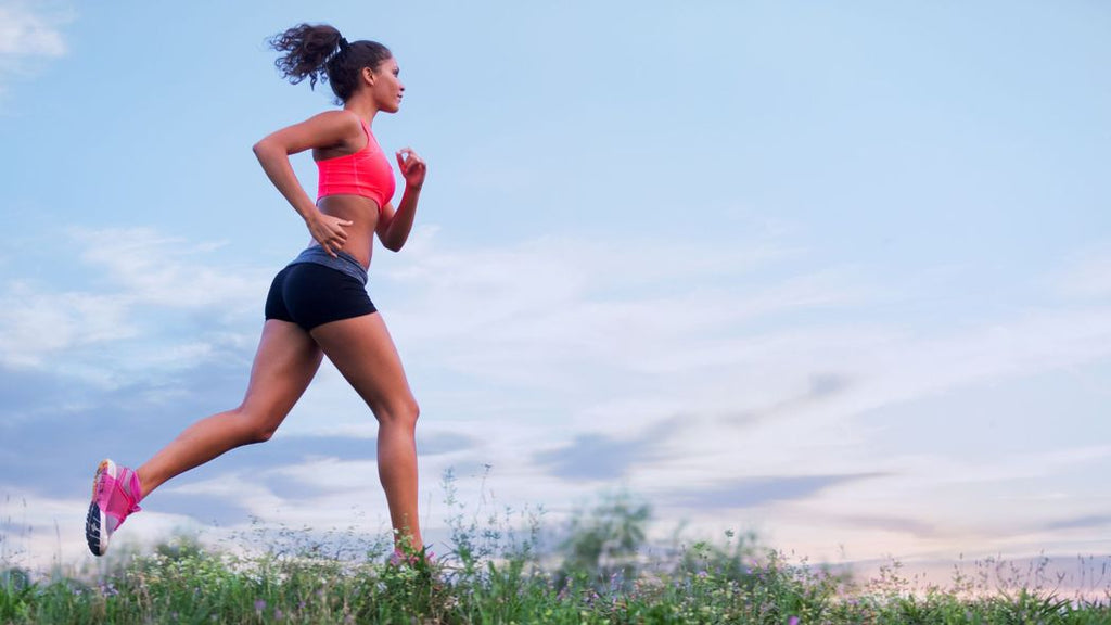 A woman jogging to burn calories and create a calorie deficit. 