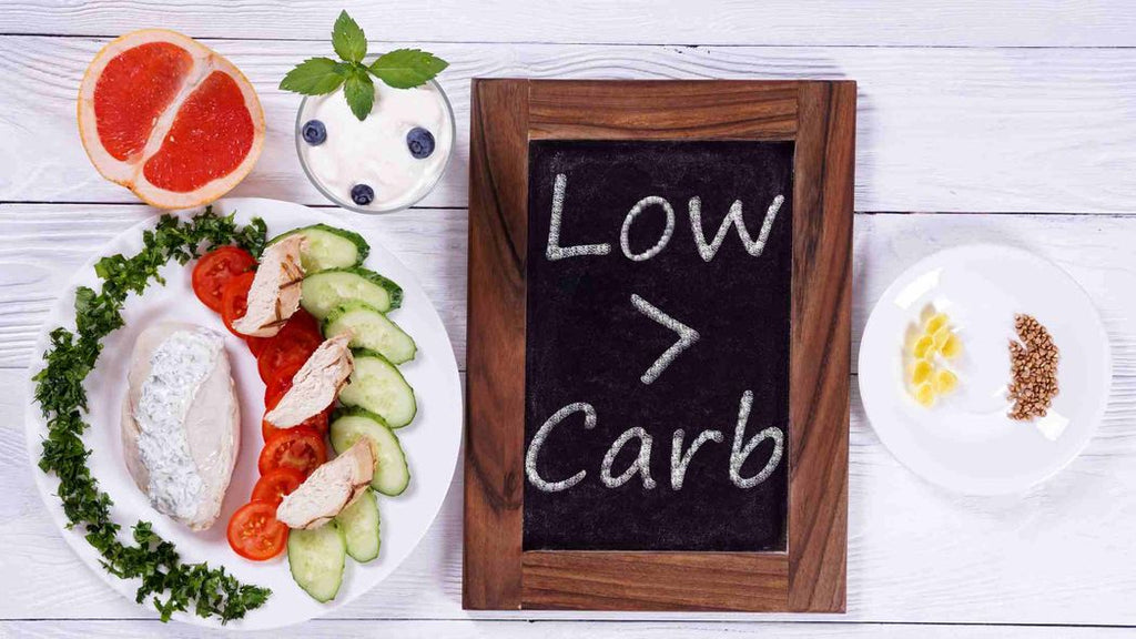 Low carb diet written on a board with low carb foods on the side. 