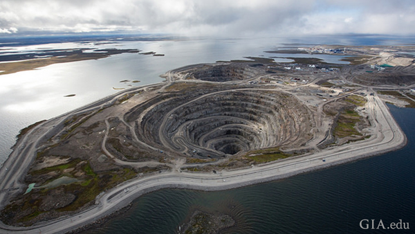 Diavik diamond mine summer A154 dike and open pit. To safely open-pit mine its ore bodies, extinct volcanoes located just offshore under the lake waters, dikes were built. Courtesy: Copyright © 2016 Rio Tinto