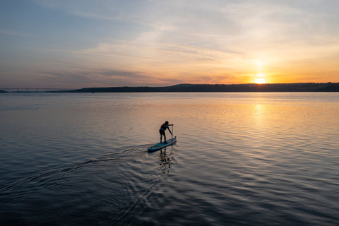 Chev Dixon paddling with the Apex91 at sunset.