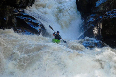 Sage Donnelly paddling down a river