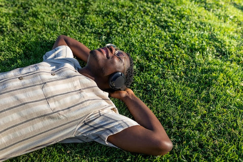 black man relaxing in grass 