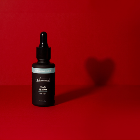 face serum black bottle on a red background with heart shadow