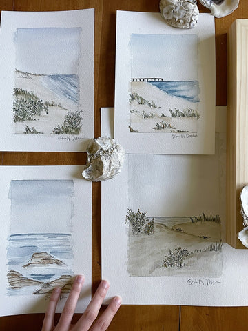 several watercolor original paintings of coastal scenes