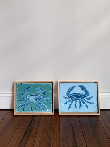 two acrylic crab paintings on canvas in a natural wood floating frame