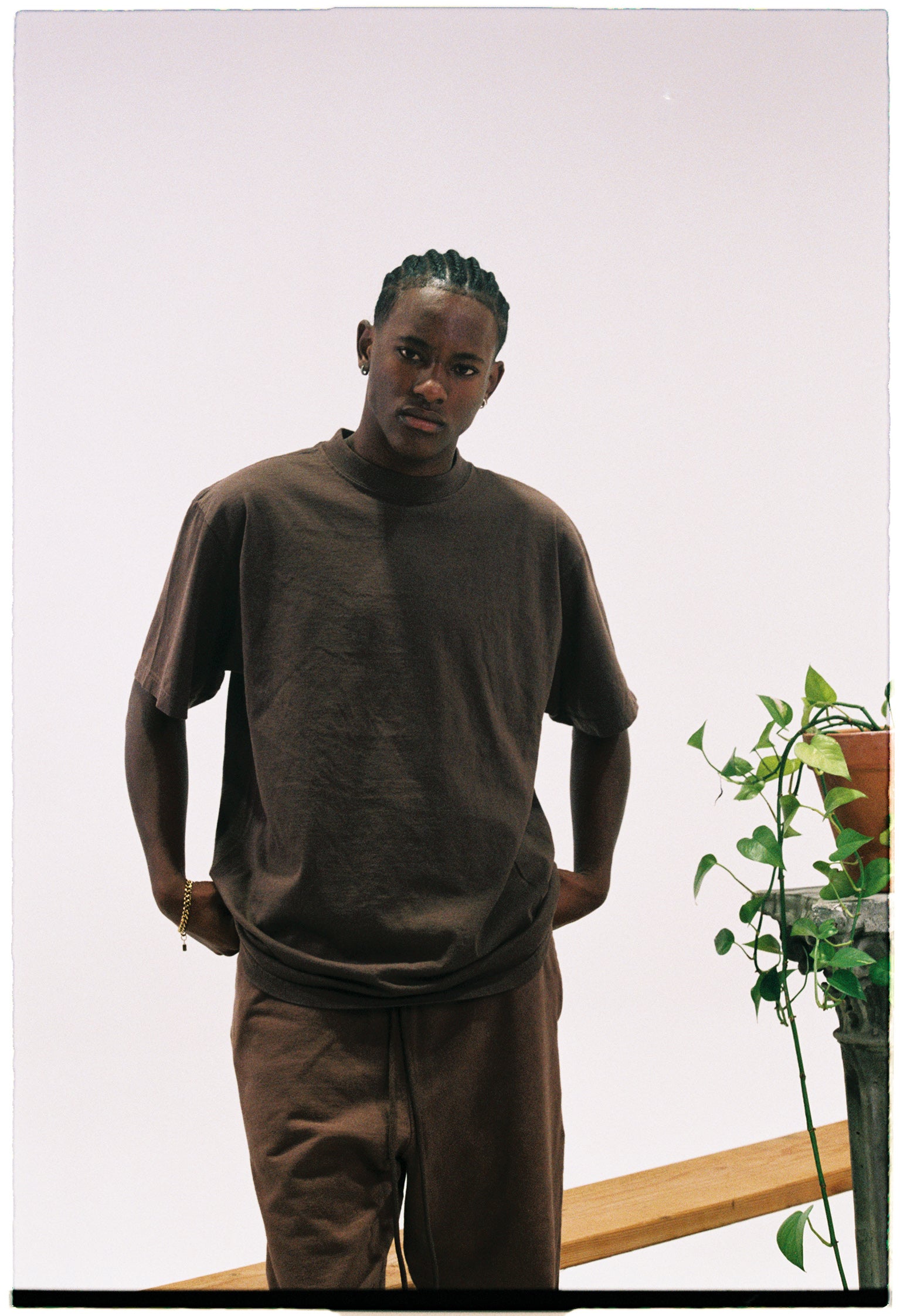 African American male standing at Shaka Wear Los Angeles Warehouse wearing garment dye clothing.