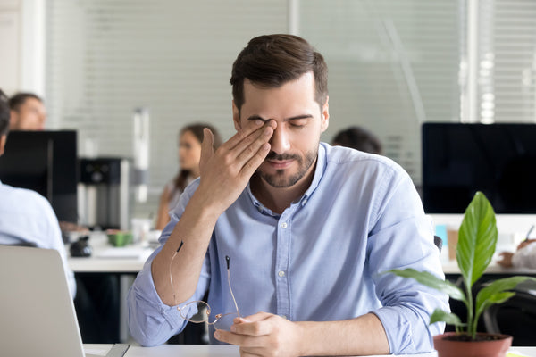 Office worker sitting desk taking off