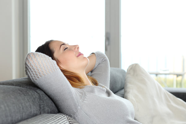 happy relaxed woman resting on couch