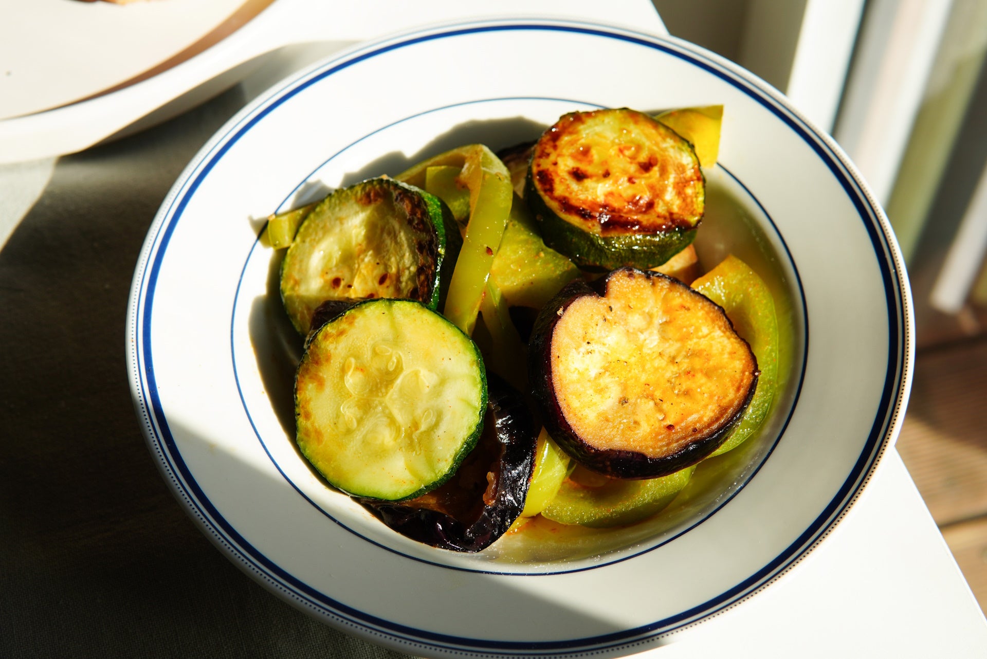 Grilled vegetables marinated in rich olive oil, a flavorful culinary delight.