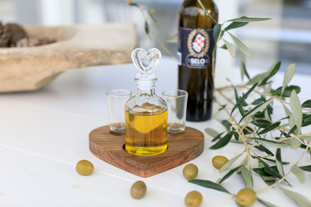 Selo Croatian Olive Oil: A bottle of authentic Croatian olive oil accompanied by olives, adorned with olive branches.