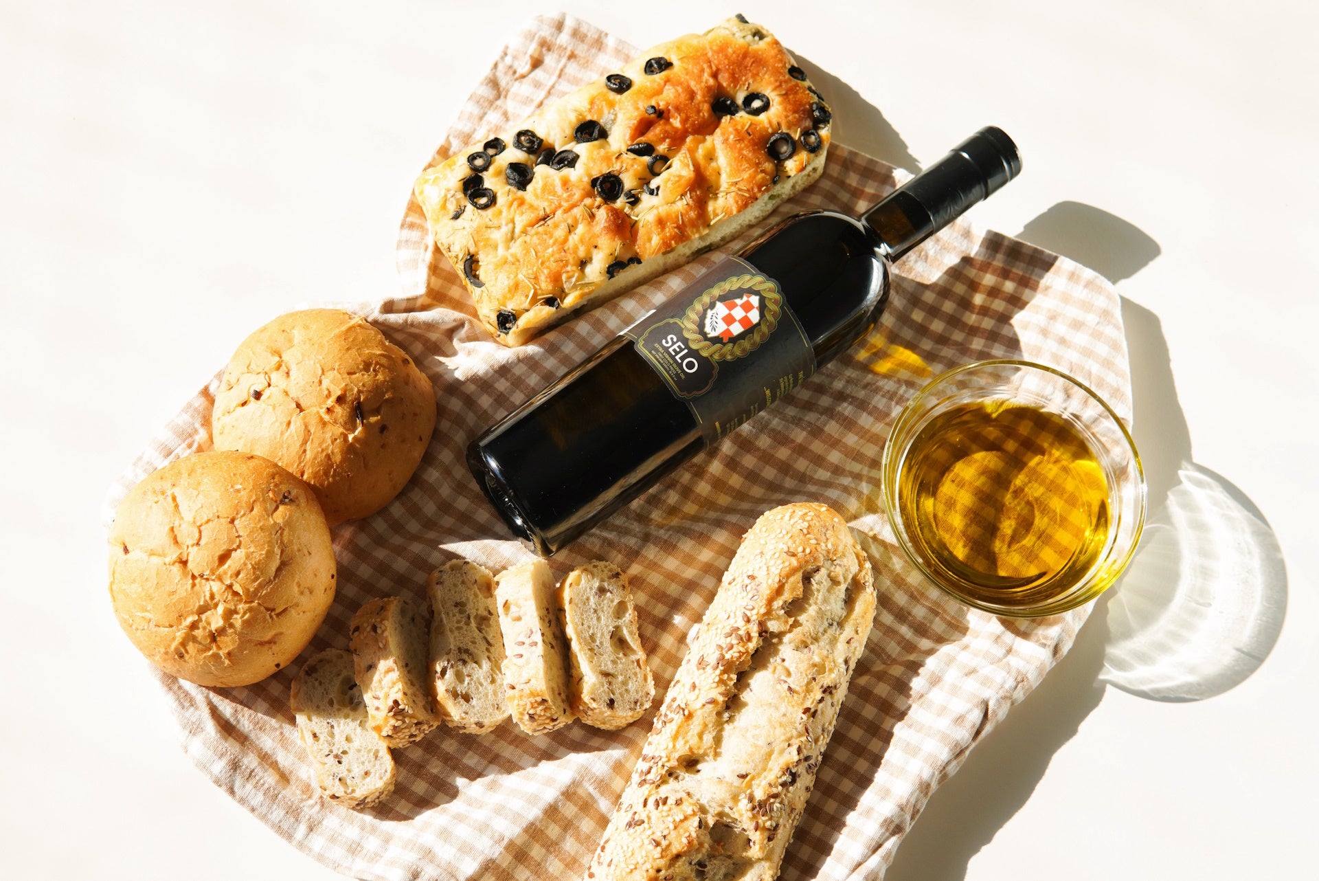 Assorted bread slices and whole grains showcased on a table, highlighting their gluten content.