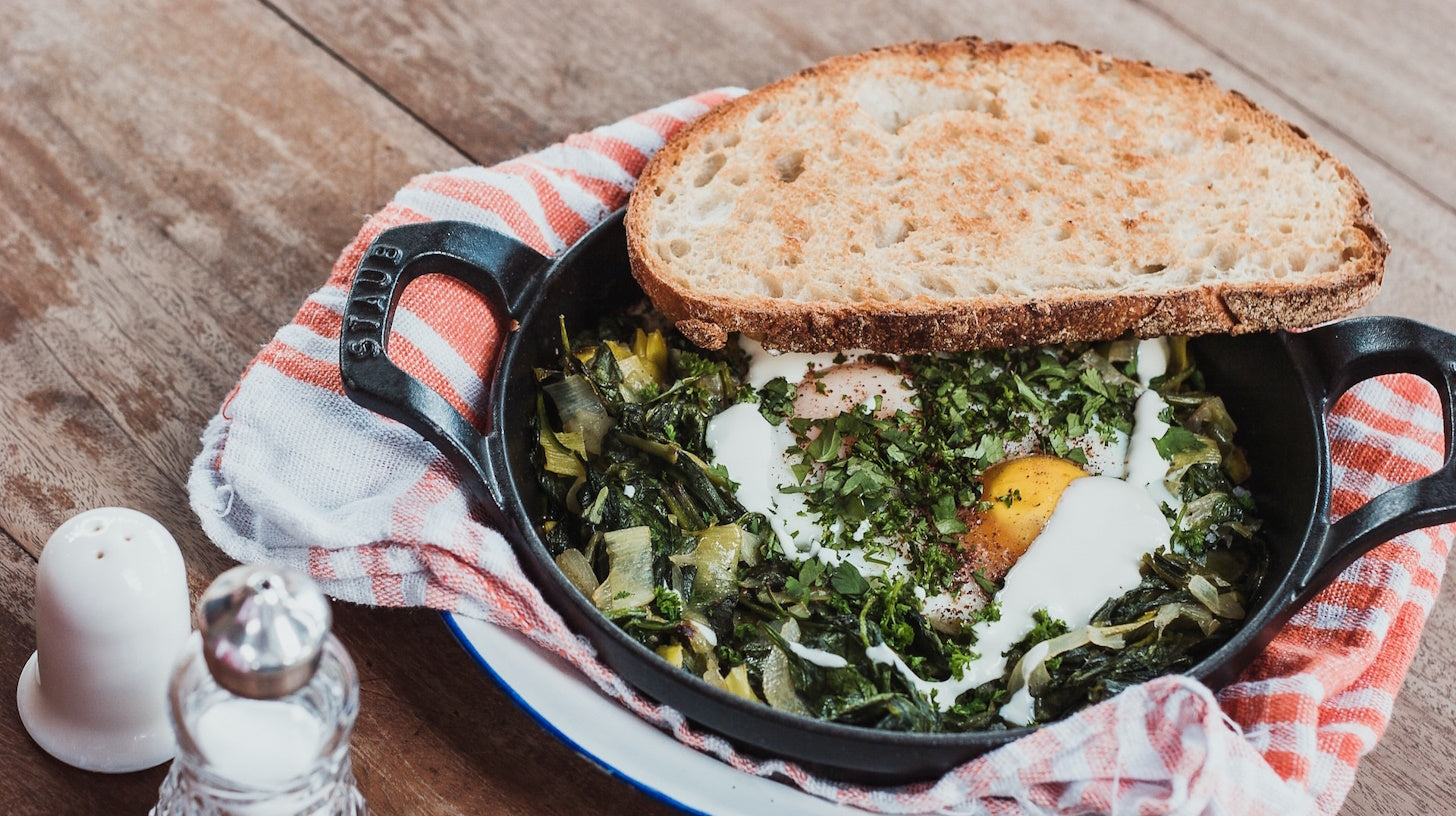 "Plate of eggs served with sautéed Swiss chard at a restaurant in Zadar, Croatia.