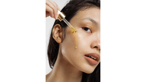 woman applying face oil 