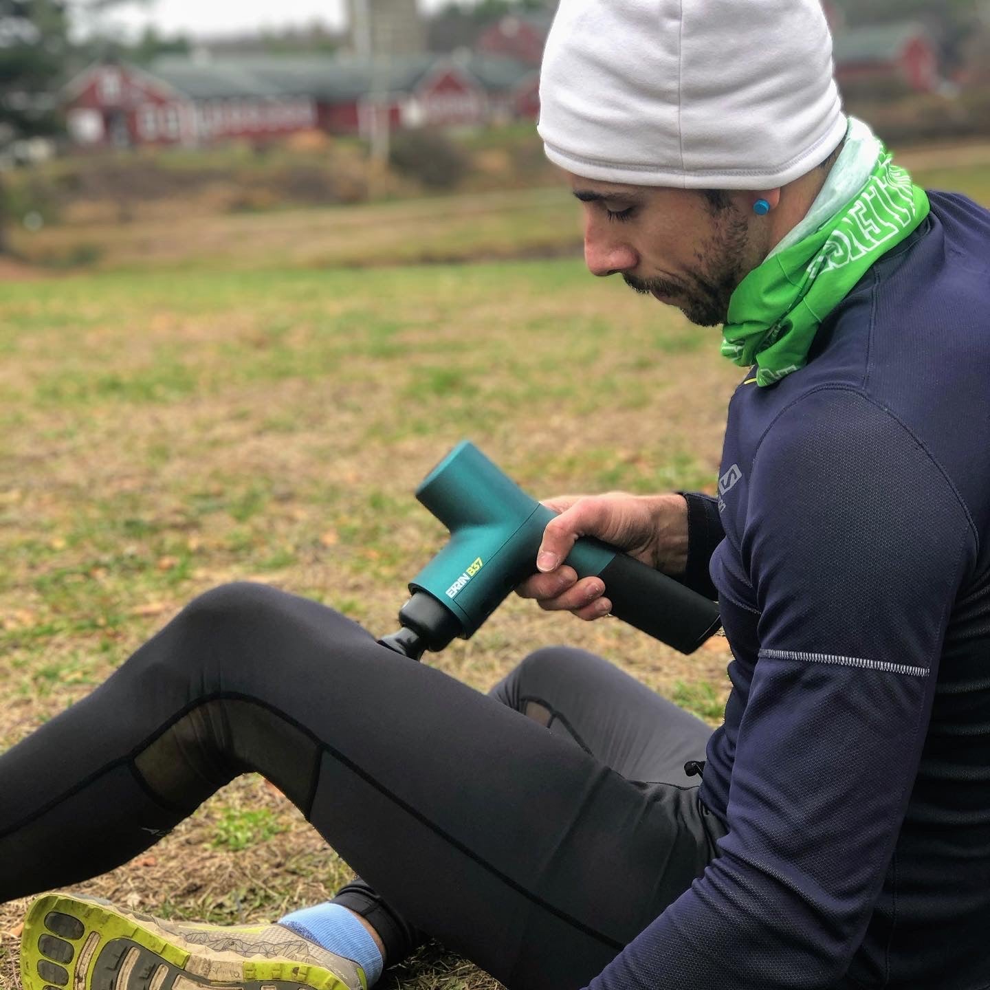 Runner warming up with a massage gun