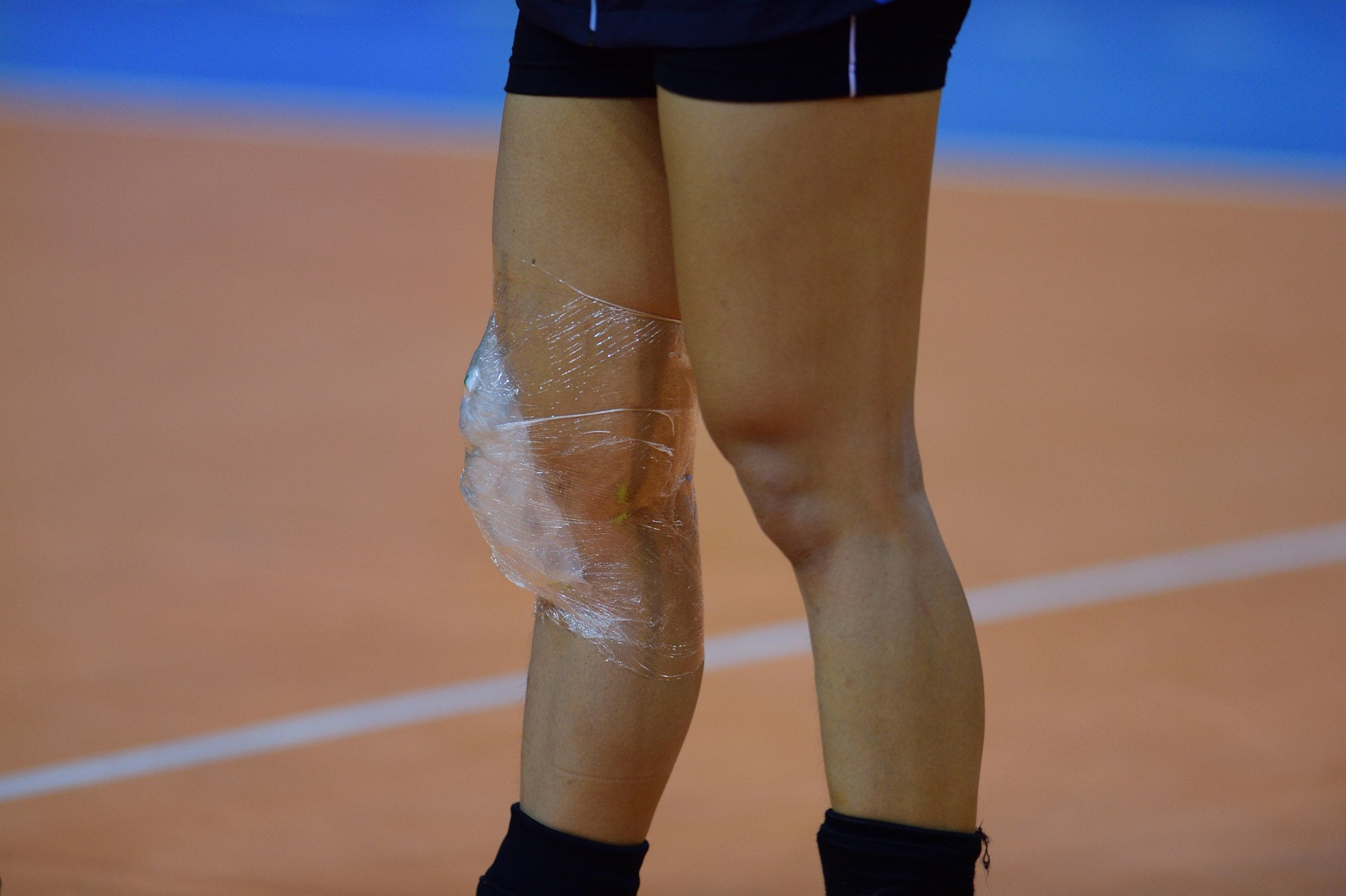 Close-up of a sport Player Icing Knee With Ice Pack On Field