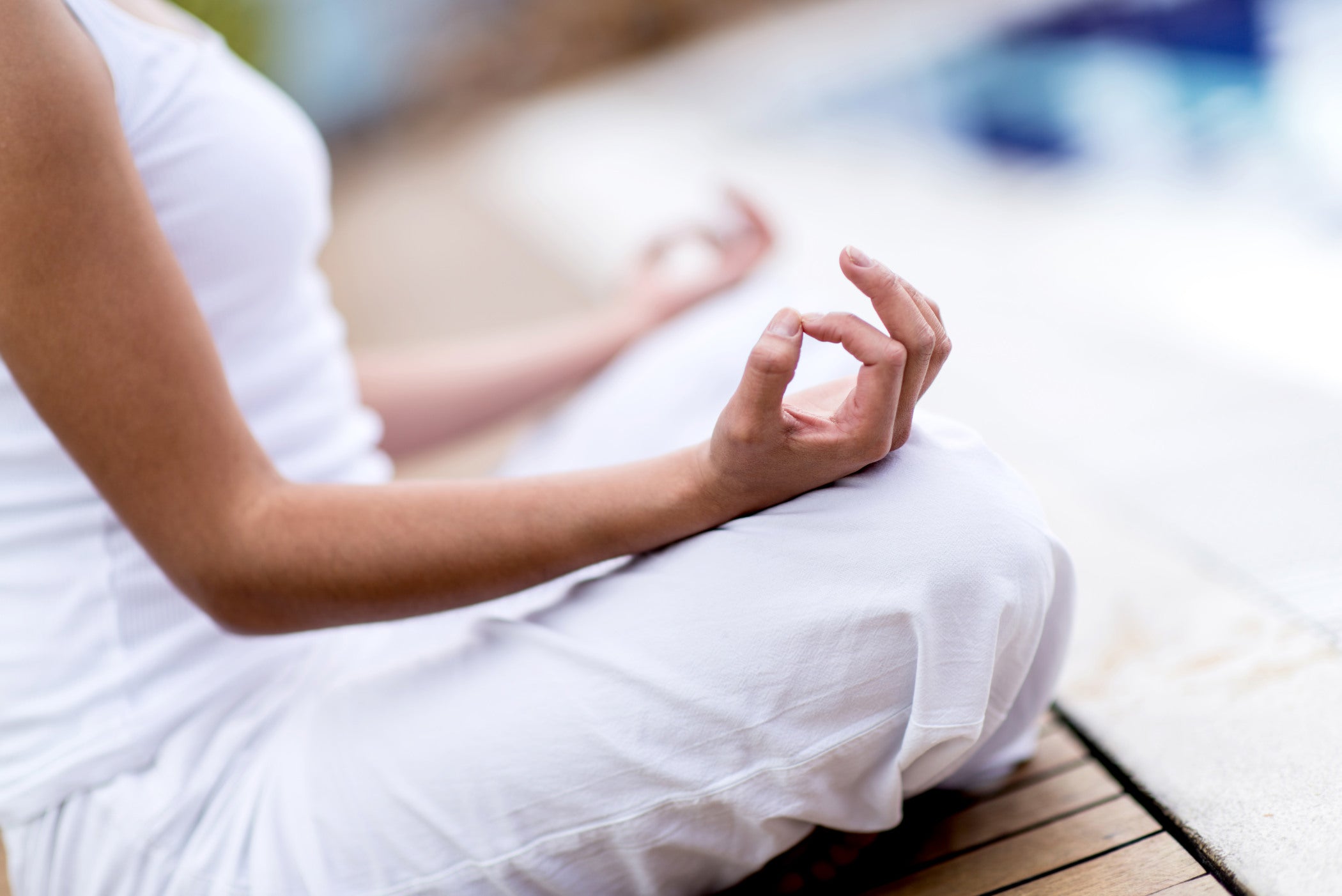Healthy woman practicing yoga in white clothing