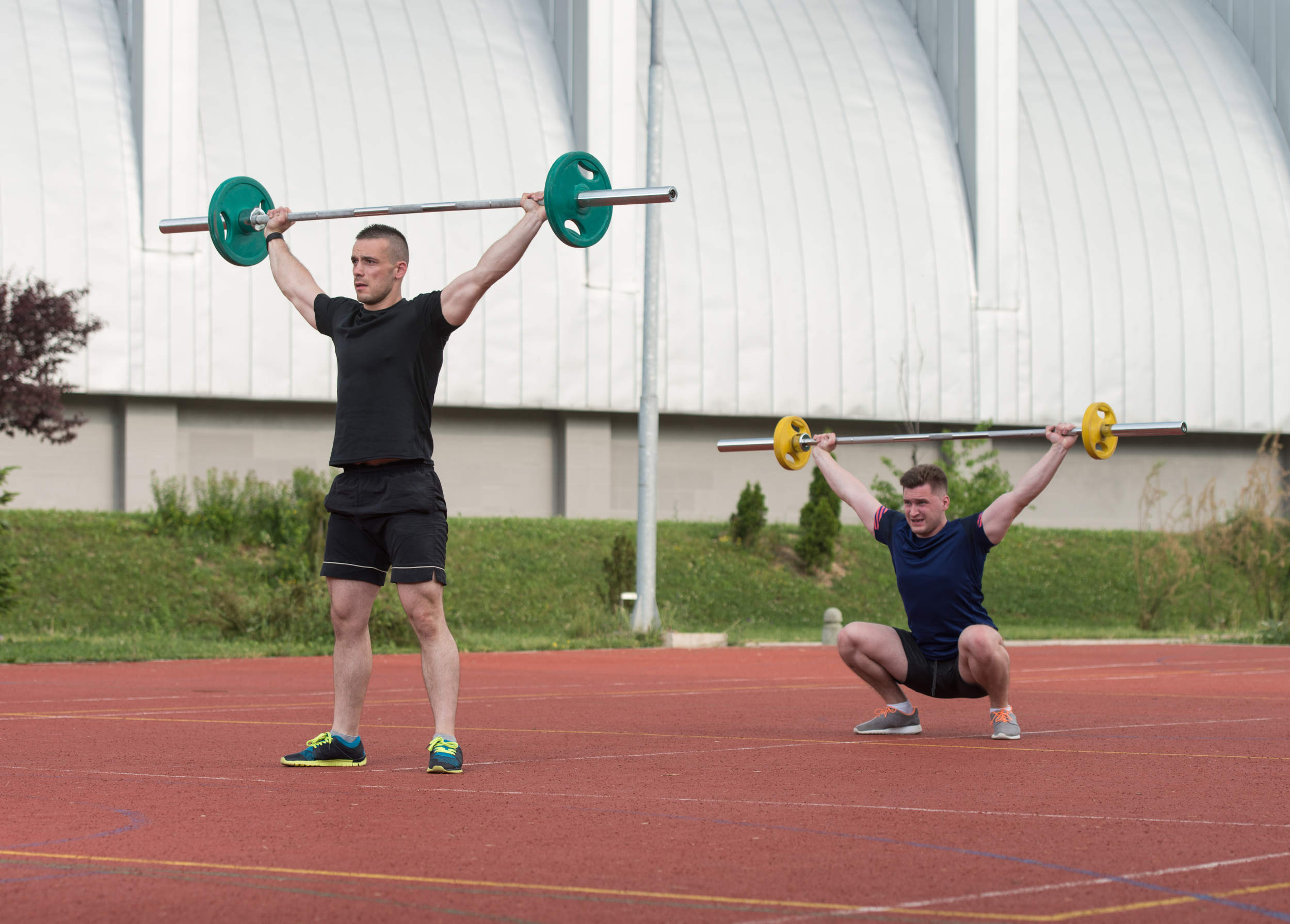 Olympic lifting outside on a track