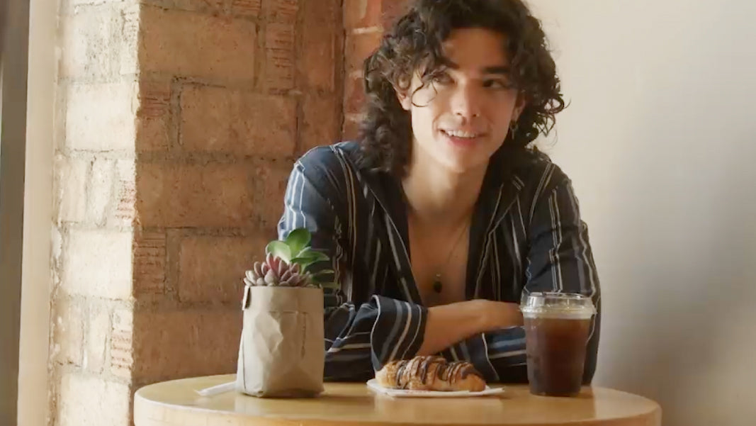 Conan Gray drinking Cafe de Olla & eating a chocolate croissant at La Monarca Bakery & Cafe during an Interview