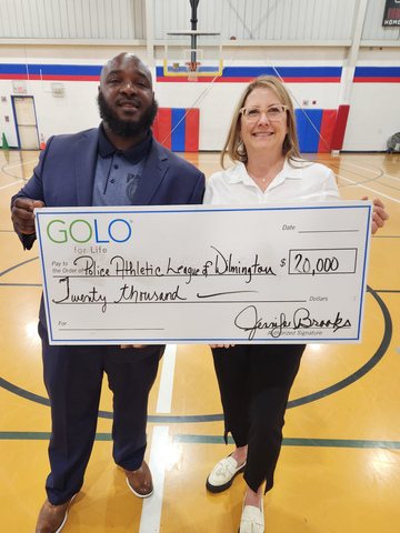 Jen Brooks presenting an honorary check to Christopher Purnell, Executive Director of the Police Athletic League of Wilmington