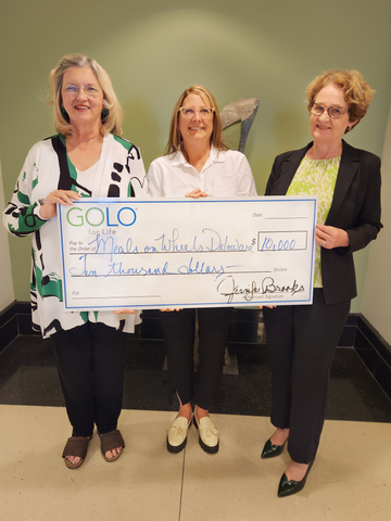 Jen Brooks presenting an honorary check to Anne Love, Executive Director of Meals on Wheels Delaware