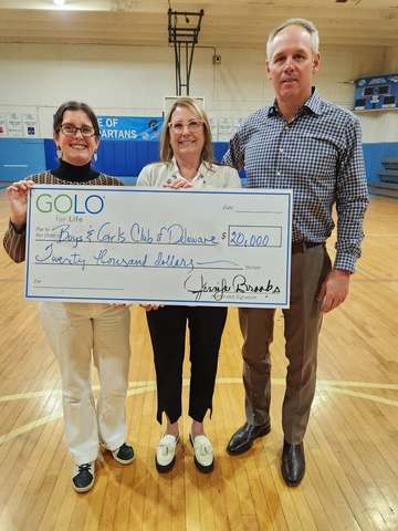 Jen Brooks presenting an honorary check to John Wellons, President and CEO at Boys & Girls Clubs of Delaware