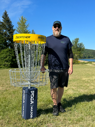 Steve Wyatt standing next to disc golf cage