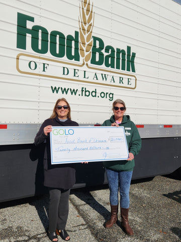 GOLO President Jen Brooks presenting ceremonial check to Cathy Kanefsky, President and CEO, Food Bank of Delaware.