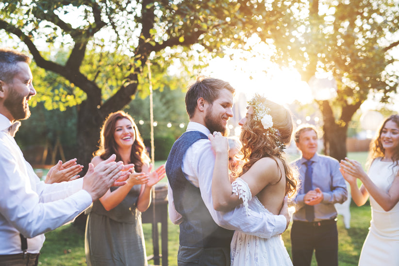 a couple dancing at an outdoor wedding